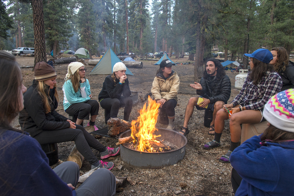 Photo of students telling stories around a campfire