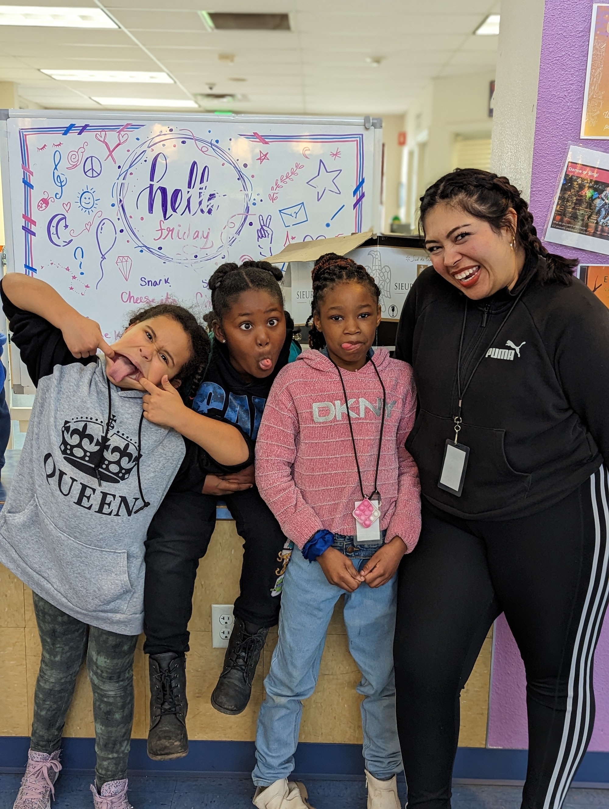 CAVE volunteer poses with children at the Boys and Girls Club