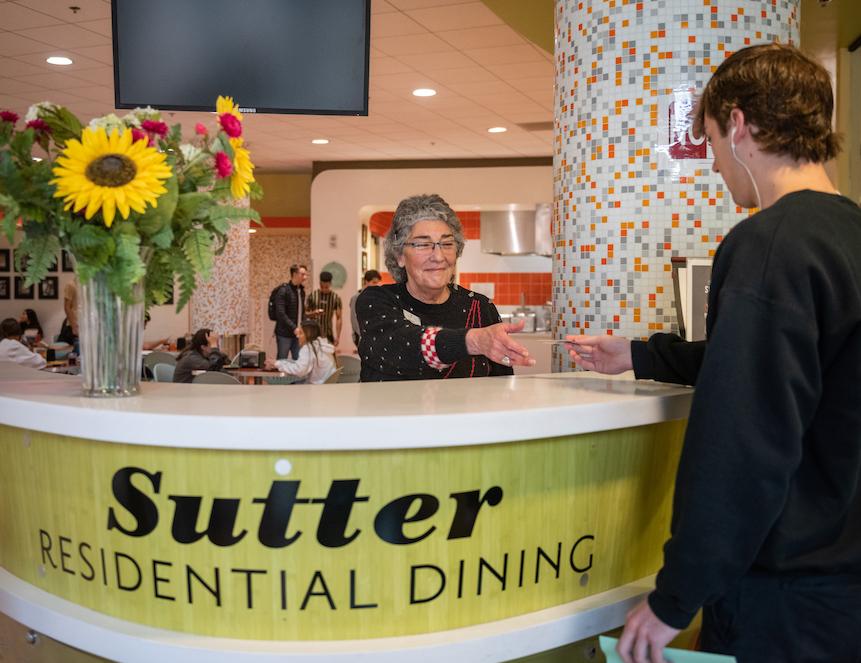 photo of man handing receptionist card