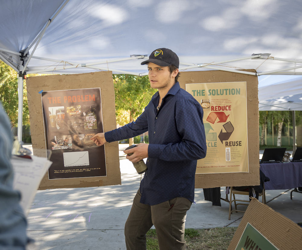 photo of man pointing to poster