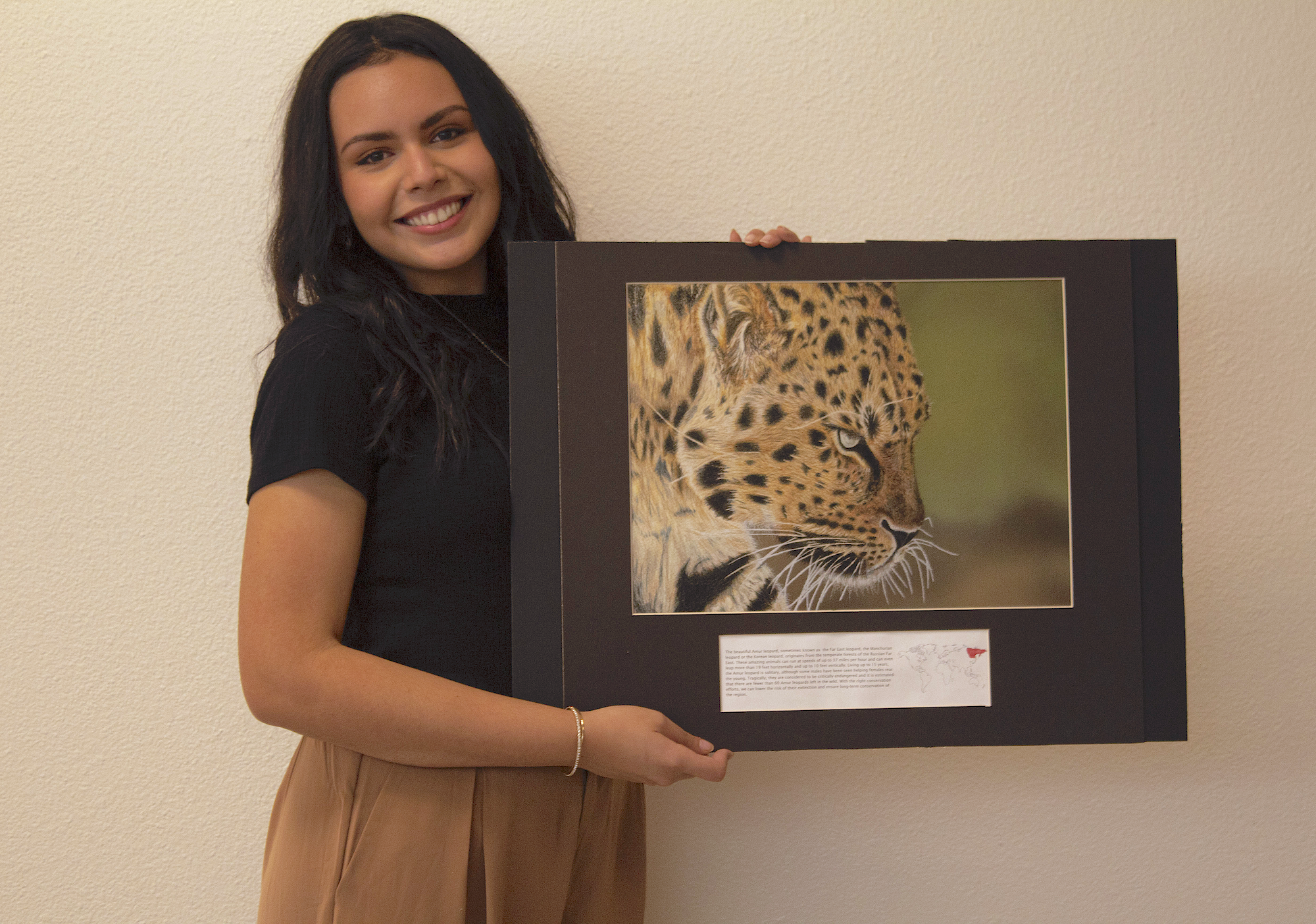 Photo of Olivia Villaseñor holding artwork