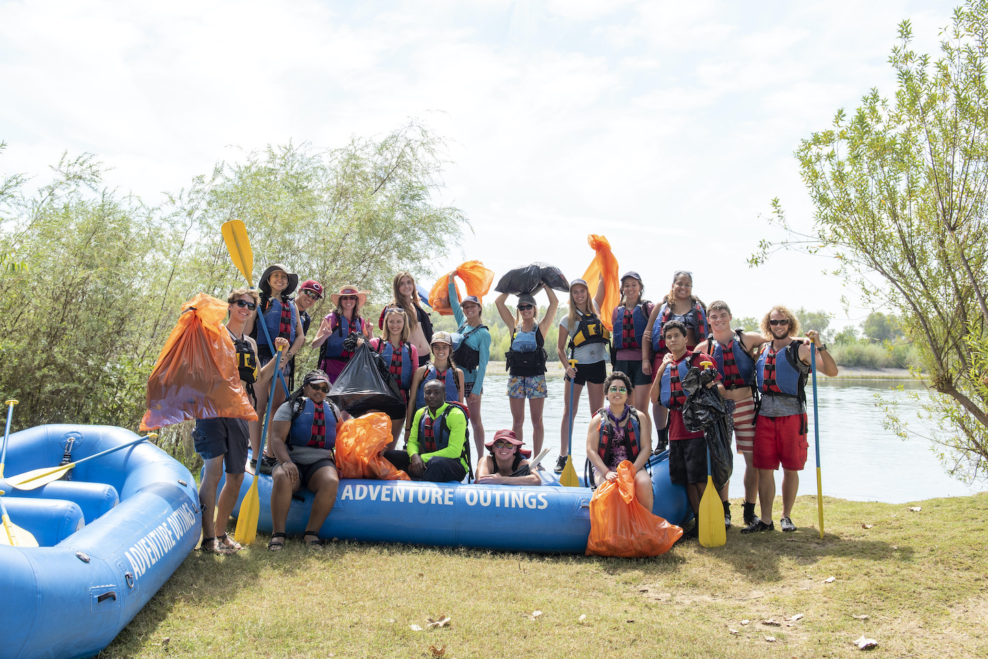 students at a river cleanup