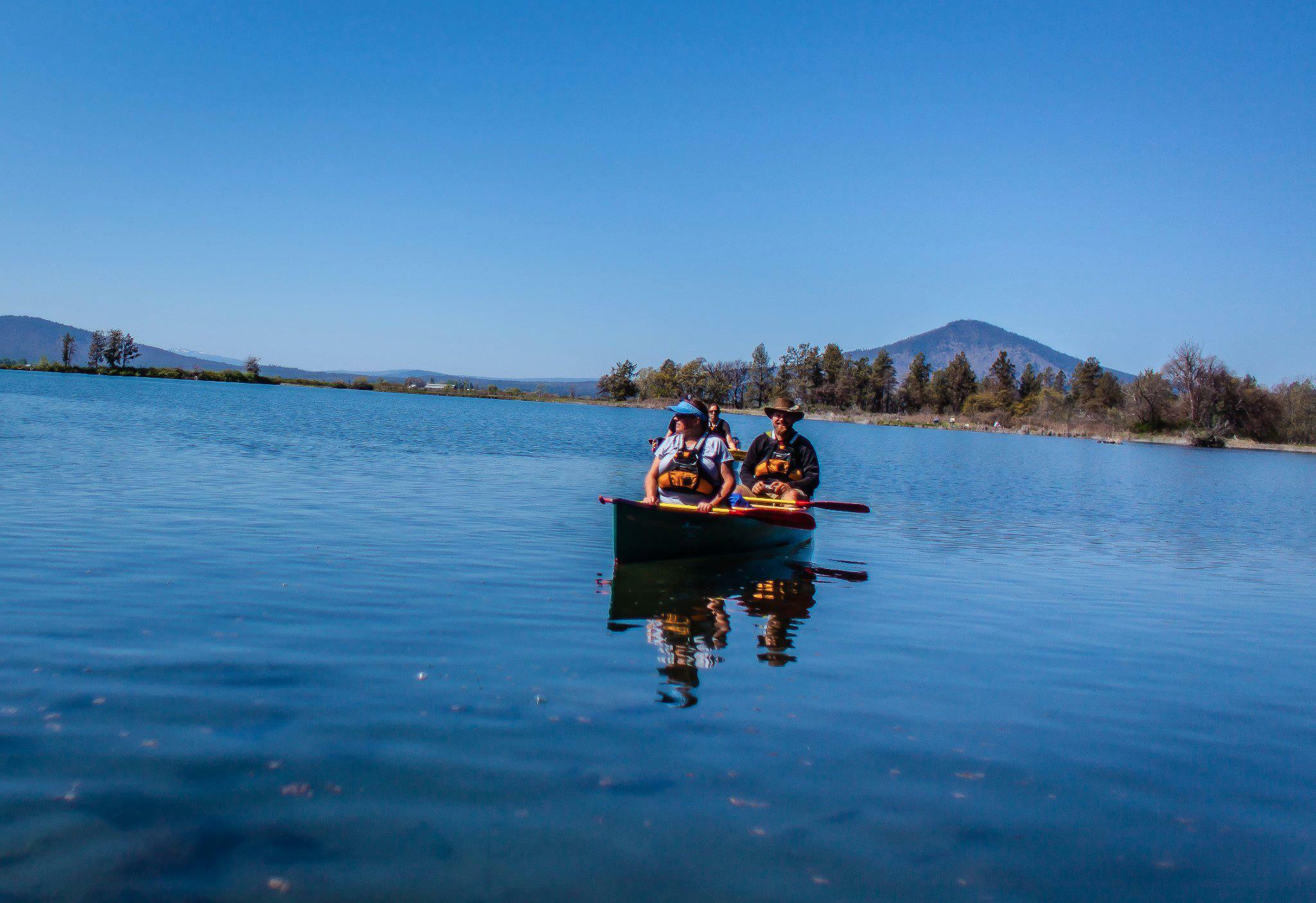 people in a canoe on a lake