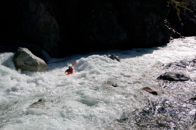 photo of kayaker on rapids