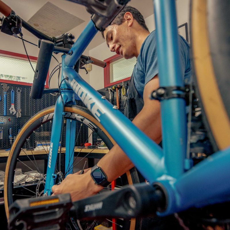 Student employees of the Bike Hub repair bikes in the Bike Hub's new location outside Holt Hall on Tuesday, Aug. 25, 2026 in Chico, Calif.  The Bike Hub, a program of Adventure Outings, offers low-cost bike maintainence, repairs, and upgrades to the campus community.
(Dash Ferrero/AS Photographer/Associated Students of CSU, Chico)