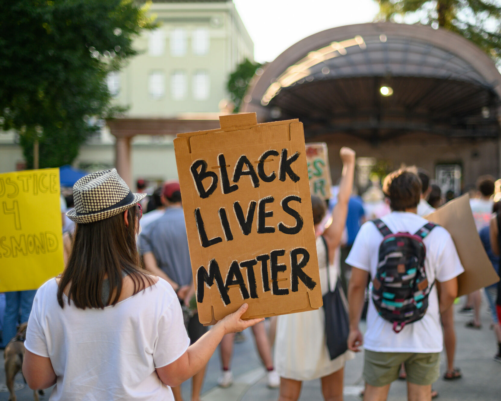 photo of woman holding sign that says "black lives matter"